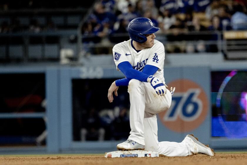 LOS ANGELES, CA - APRIL 1, 2024: Los Angeles Dodgers first baseman Freddie Freeman (5) kneels at second base during a play review after hitting an RBI double against the San Francisco Giants in the seventh inning at Dodger Stadium on April 1, 2024 in Los Angeles, California. (Gina Ferazzi / Los Angeles Times)