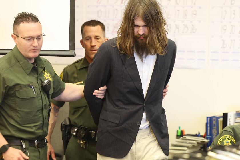 SANTA ANA, CA APRIL 9, 2024 - Orange County Deputy Sheriffs escort Samuel Lincoln Woodward into Orange County Superior Court for Opening Statements of the murder trial for the stabbing death of Blaze Berstein on April 9, 2024 in Santa Ana, California. (Frederick M. Brown/Daily Mail/Pool Photo)