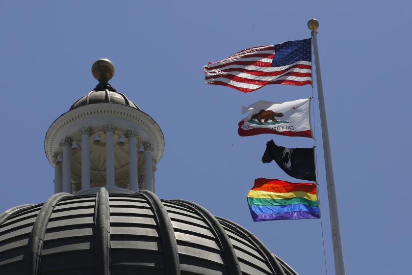 The rainbow Pride flag flutters from the flag pole at the state Capitol in Sacramento in June 2019.