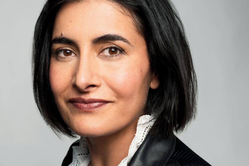 Priyanka Mattoo, in a leather jacket and short bob, smiles at the camera. 