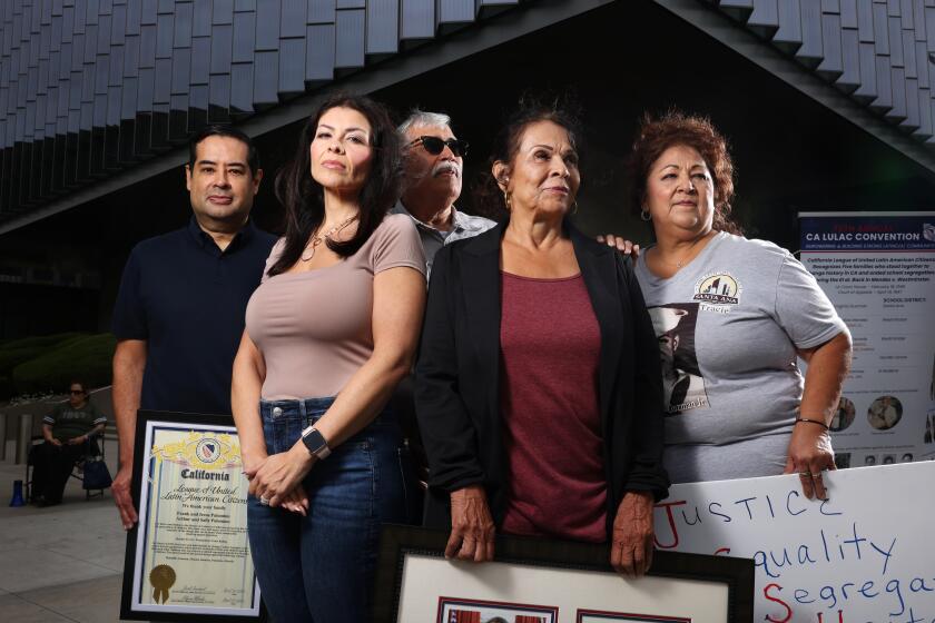 LOS ANGELES-CA-JUNE 8 2024: Andrew Palomino, Connie Pimentel-Reagins, Michael Ramirez, Beverly Guzman Gallegos, and Tracie Guzman, from left, the family members of the omitted plaintiffs who participated in a lawsuit that helped to end school segregation in California, gather outside of the U.S. Federal Courthouse in downtown Los Angeles on June 8, 2024. Congress is mulling a bill to name the U.S. Federal Courthouse in downtown Los Angeles after Gonzalo and Felicitas Mendez, one of the five families who stood together to end school segregation in California. The four other families; Guzman, Estrada, Palomino and Ramirez oppose the bill. (Christina House / Los Angeles Times)