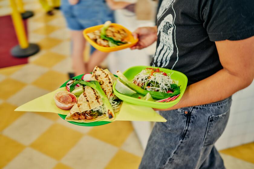 LOS ANGELES, CA - OCTOBER 6: Dishes fly by at the Mid-City location of Sonoratown on Friday, October 6, 2023 in Los Angeles, CA. (Shelby Moore / For The Times)