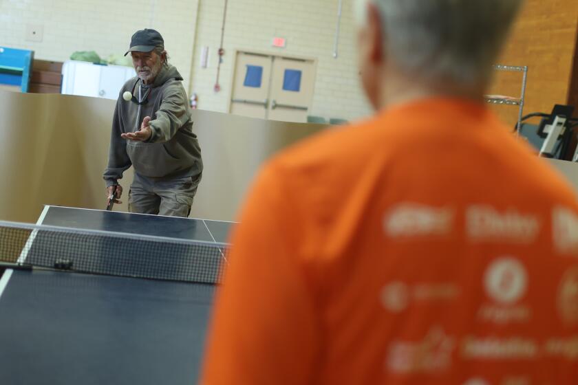 North Hills, CA - March 14: Ray Emmons , 76, left, plays ping pong on the other side of Conrad Amers, 71, right, during golden age games training at Sepulveda VA Medical Center on Thursday, March 14, 2024 in North Hills, CA. (Michael Blackshire / Los Angeles Times)