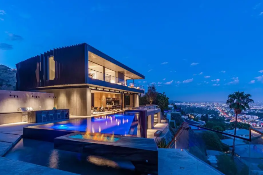 Newly built, the ultra-modern residence spans three stories with five bedrooms, six bathrooms and amenities such as a movie theater and game room.