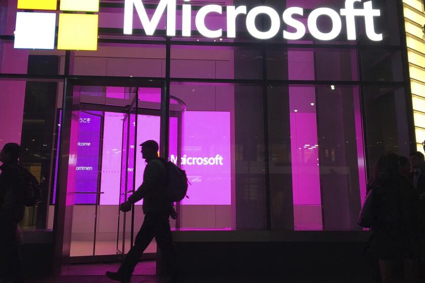 FILE - In this Nov. 10, 2016, file photo, people walk past a Microsoft office in New York. Microsoft says it is making a “multiyear, multibillion dollar investment” in the artificial intelligence startup OpenAI, maker of ChatGPT and other tools that can generate readable text, images and computer code. The tech giant on Monday, Jan. 23, 2023 described its new agreement as the third stage of a growing partnership with San Francisco-based OpenAI that began with a $1 billion investment in 2019. (AP Photo/Swayne B. Hall, File)