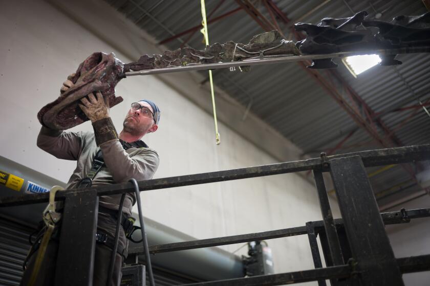 Mounting Technician Kevin Krudwig installs a temporary styrofoam head on "Natalie" at Research Casting International 