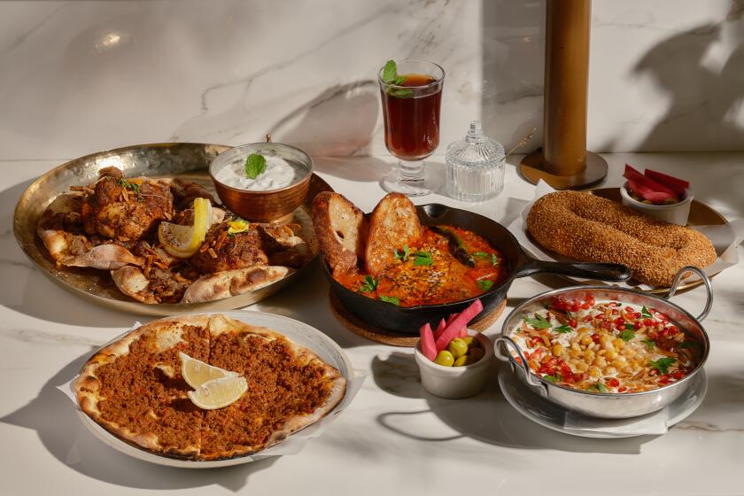 LONG BEACH , CA - OCTOBER 21: (Clockwise from top left) The musakhan, shakshouka, the jerusalem bagel, the fattet hummus, and the meat manoushe at Ammatoli on Friday, Oct. 21, 2022 in Long Beach , CA. (Shelby Moore / For The Times)