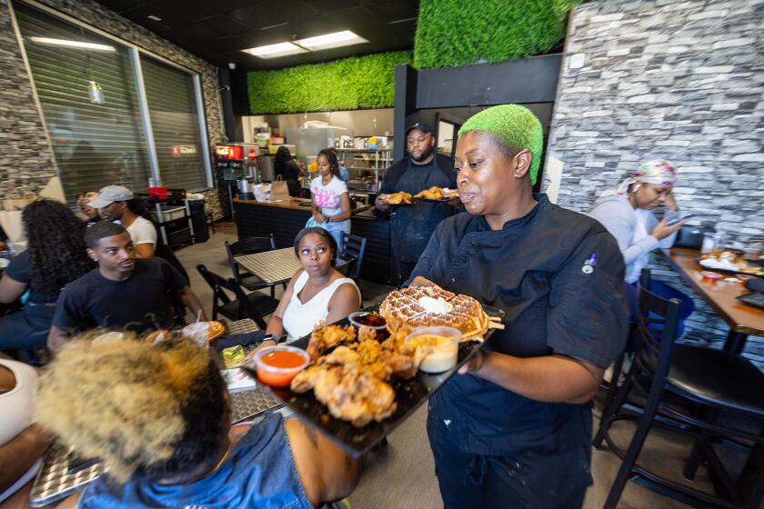 Los Angeles, CA - June 27: Gritz N Wafflez owner Jurni Rayne at Gritz N Wafflez in Los Angeles Thursday, June 27, 2024. High interest rates have affected consumers and small businesses. Gritz N Wafflez is a brunch diner, started two years ago by owner Jurni Rayne. She began with a ghost kitchen offering delivery service, and moved to this location, 1.5 miles west of the Staples Center, about a year ago. It'll be moving again this fall to a bigger space in Koreatown as the restaurant has become very popular. She says she might have moved even sooner had interest rates and financing been more favorable. (Allen J. Schaben / Los Angeles Times)