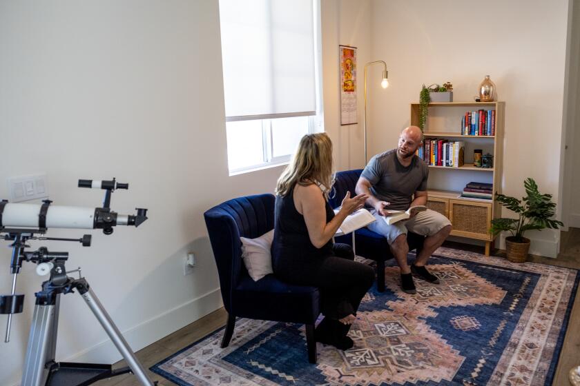 LA QUINTA, CA - APRIL 30, 2024: Chelsey and Spencer Marks spend time on the second floor reading area inside their home at SolTerra housing development which includes one and two-story units with three or four bedroom plans and rent rates starting at $3,800 per month on April 30, 2024 in La Quinta, California. There is a growing trend across the country and in Southern California to build new suburban subdivisions of single-family homes that are only for rent. (Gina Ferazzi / Los Angeles Times)