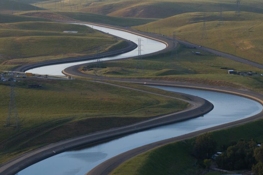 BYRON, CA APRIL 18, 2024 - The California Aqueduct meanders its path from north to south, lower, on Thursday, April 18, 2024 in Byron, Calif. (Paul Kuroda / For The Times)