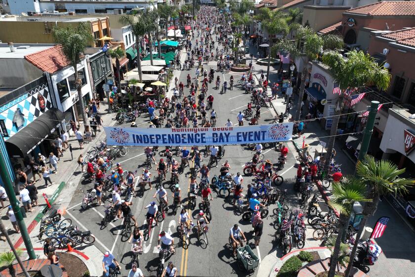 Huntington Beach, CA - June 29: Hundreds of patriotic bicyclists cruise down Main Street during the 5th Annual Huntington Beach Locals 4th of July Bicycle Cruise in advance of the annual Independence Day parade and fireworks in Huntington Beach. Kids, families, pets and neighbors were led by the Huntington Beach Veterans in the parade which began at Yorktown Ave. and Main Street, ending at Main Street and Walnut Ave. in Huntington Beach Saturday, June 29, 2024. (Allen J. Schaben / Los Angeles Times)