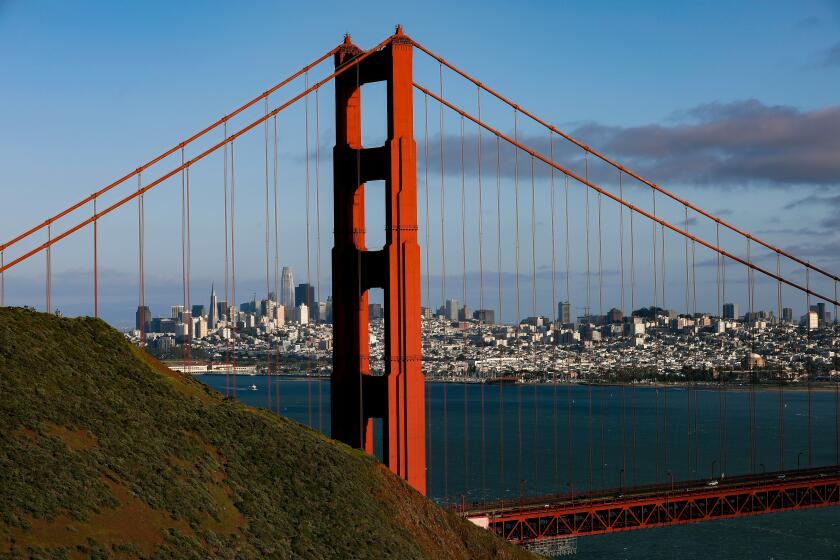 SAN FRANCISCO, CA - MARCH 13: The skyline of downtown San Francisco with the Golden Gate bridge in the foreground taken from Golden Gate view point on Saturday, March 13, 2021 in San Francisco, CA. On March 2, 2021, the San Francisco Department of Public Health updated a COVID-19 health order to allow many businesses to reopen at the Red Tier. (Gary Coronado / Los Angeles Times)